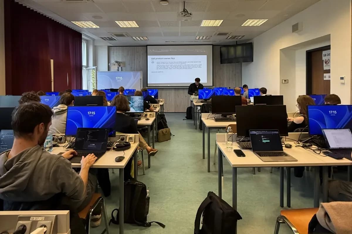 Students at their computers during a 4IT580 seminar at VŠE, with a slide titled 'Your product owner says' on the projector